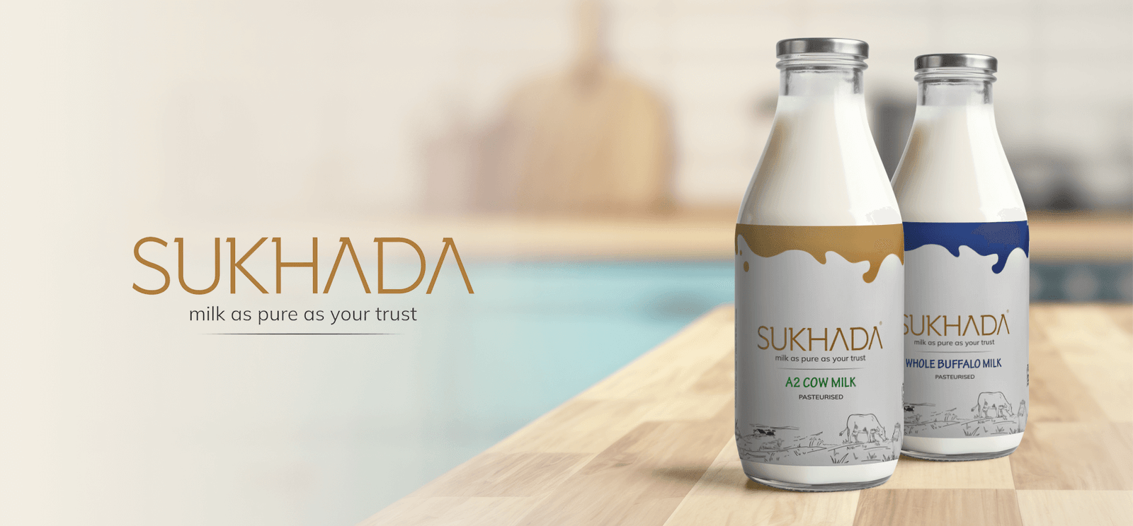Sukhada Milk branding design with A2 cow milk and whole buffalo milk glass bottles design & mockups.